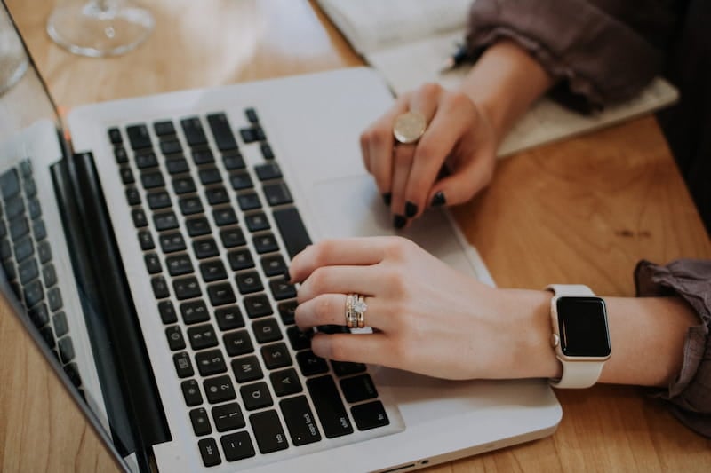 Woman at desk with laptop, writing a functional resume